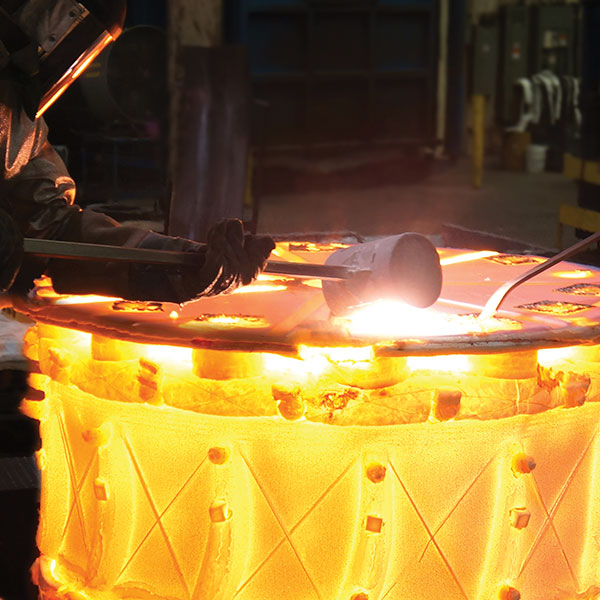 person working with large casting